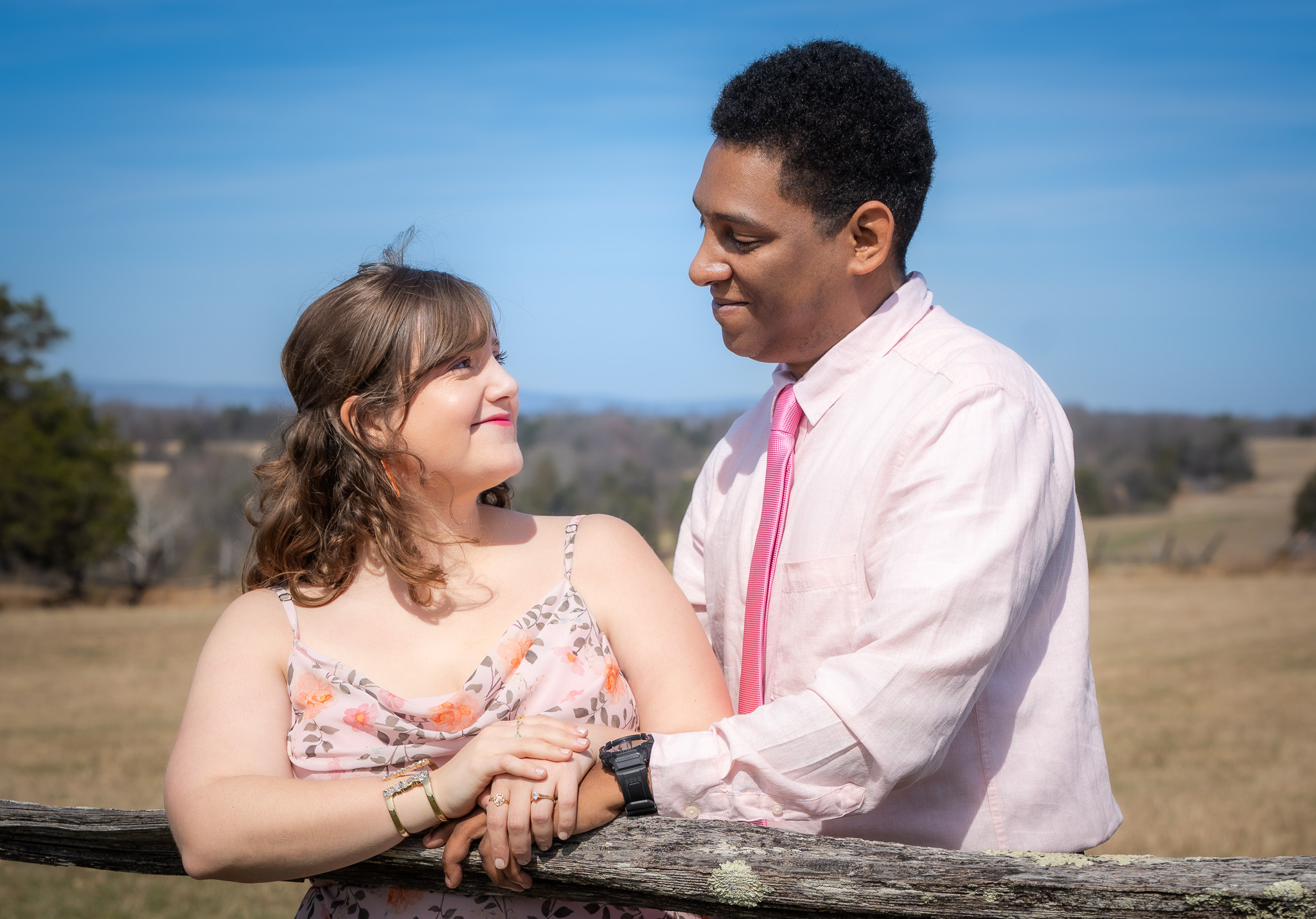 Couple smiling together in an open field