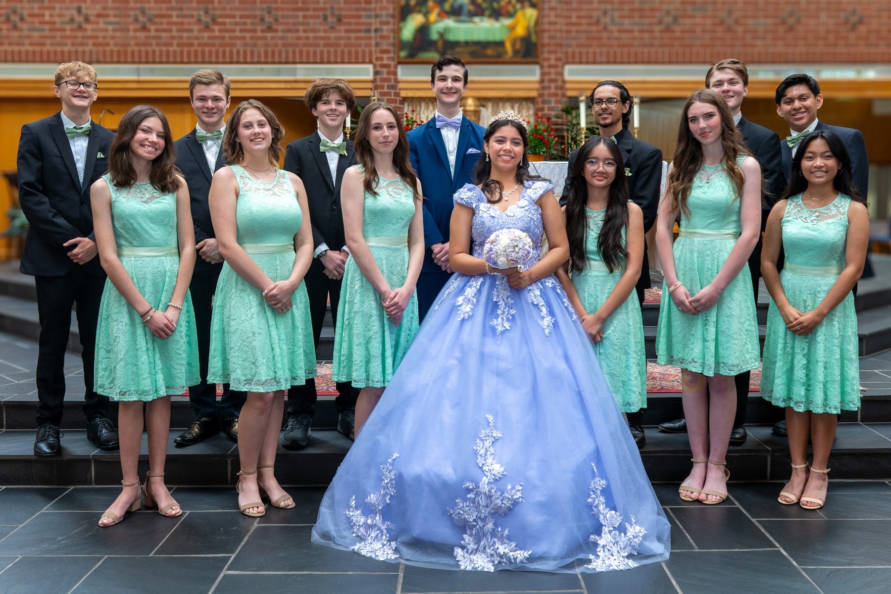 Quinceanera court standing together outdoors
