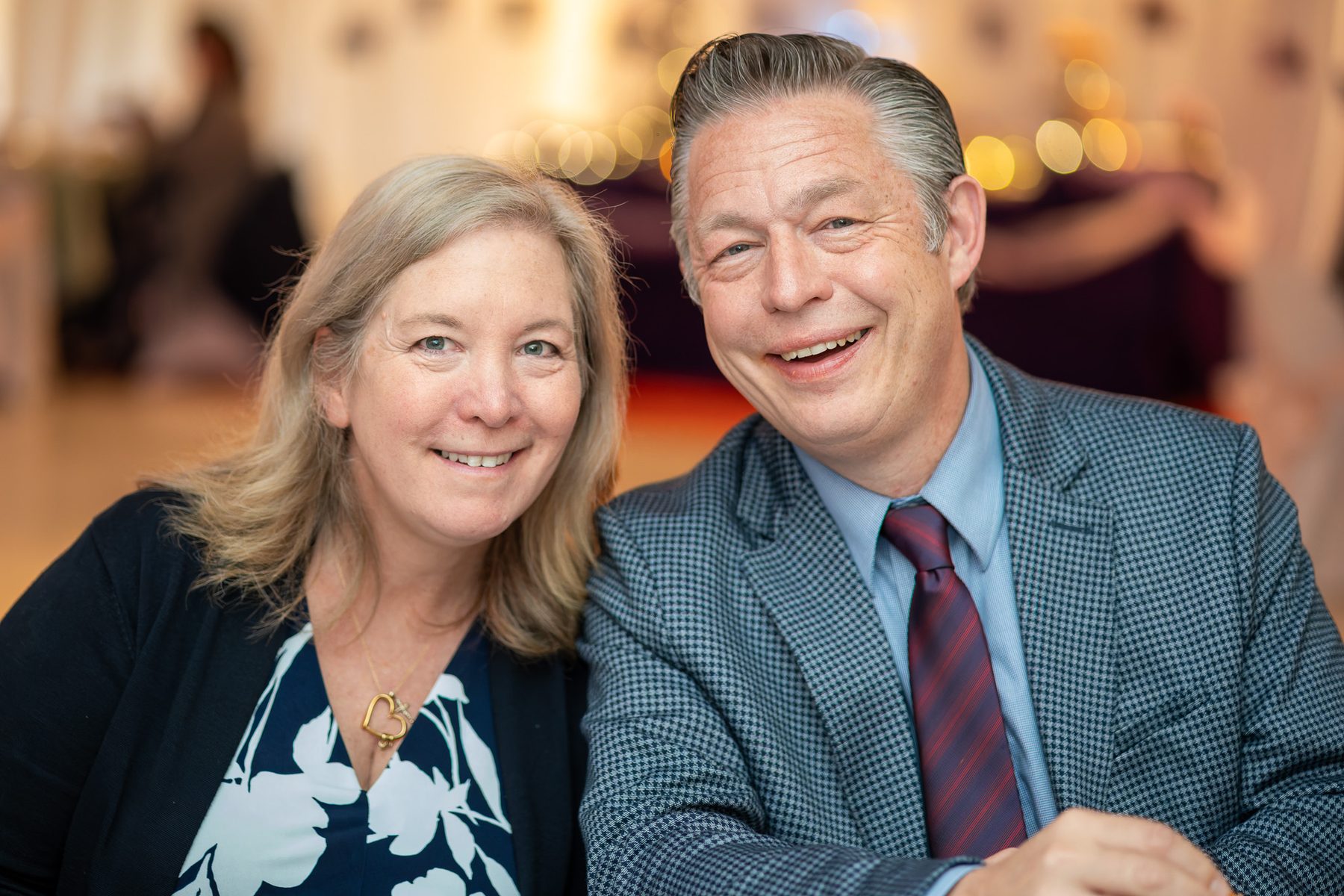 Couple smiling together at a reception table