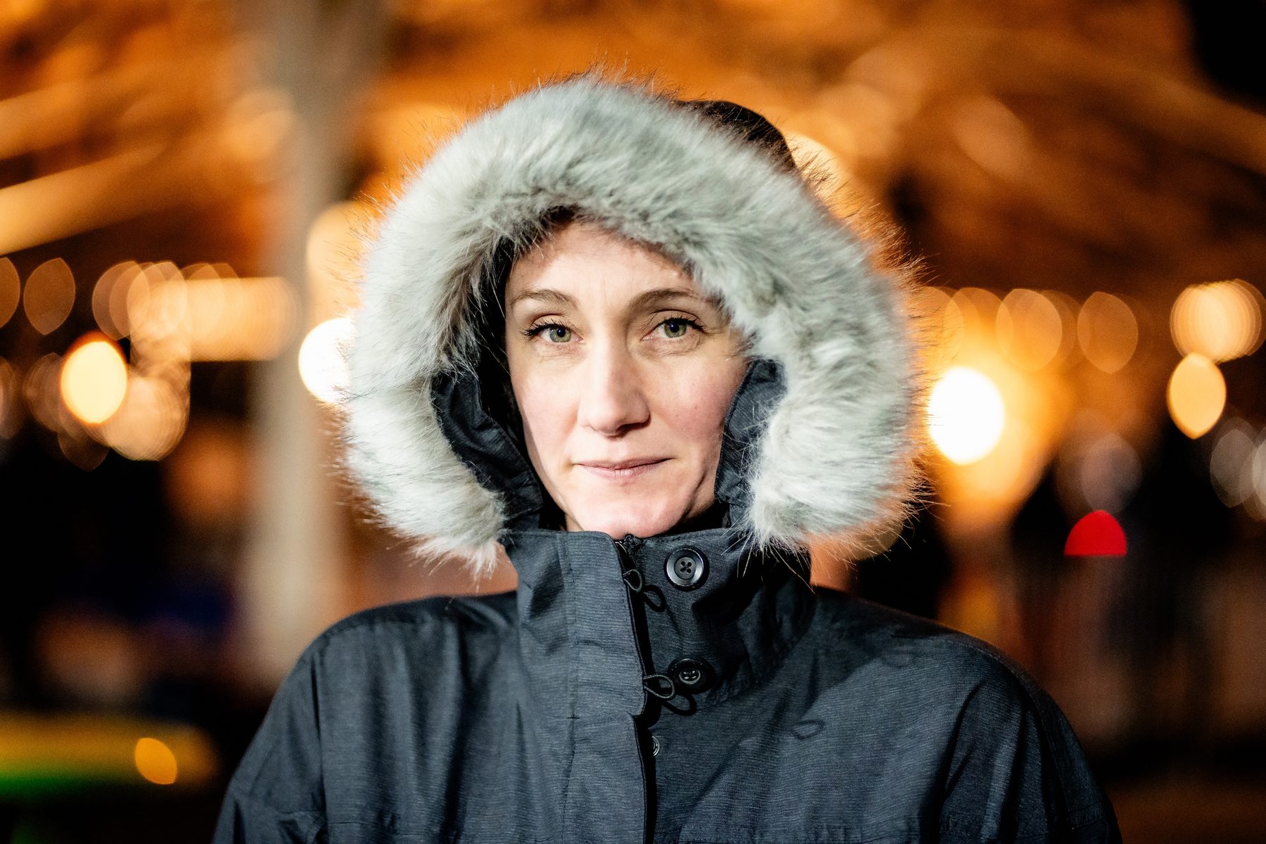 Winter portrait with warm lights in the background