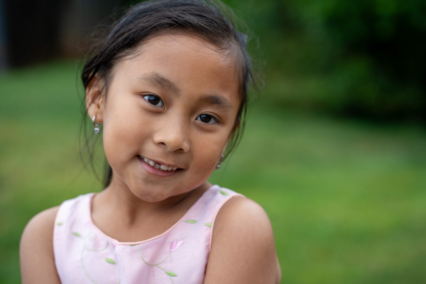Child portrait outdoors in soft green light